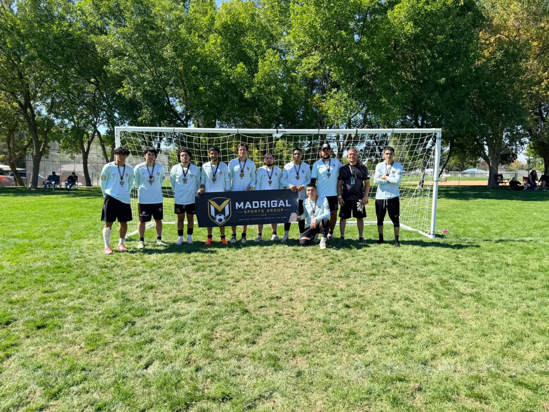 Copa Tricolor team posing in front of a goal